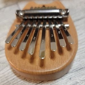 Mini kalimba  instrument with key chain and necklace accessories.  In gift box